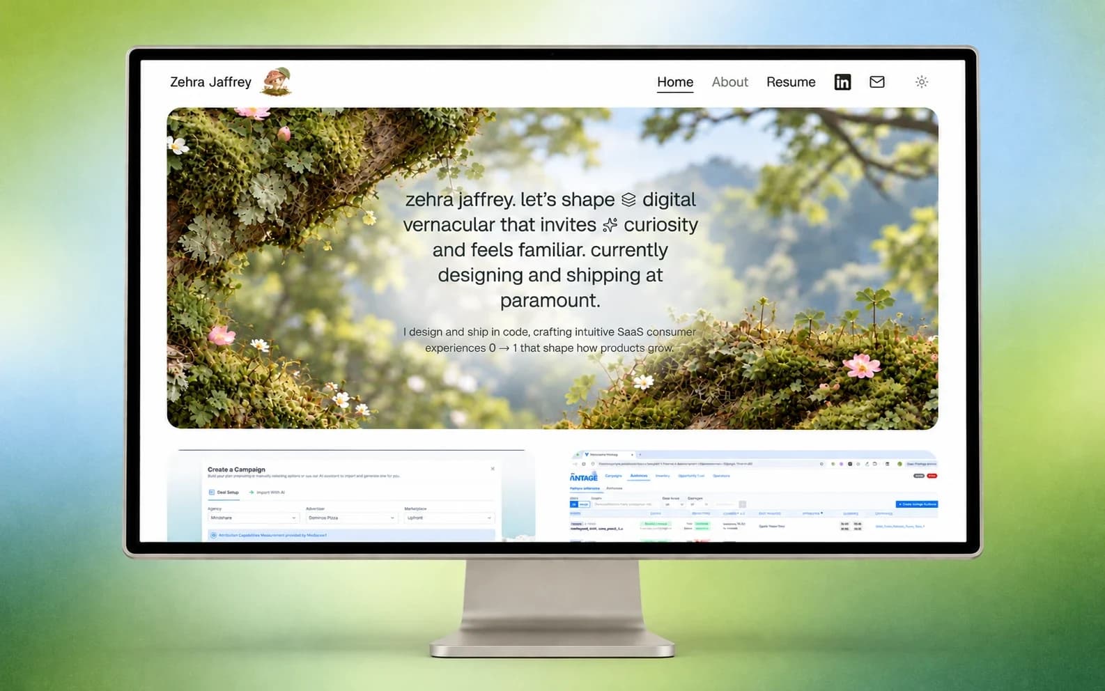 The portfolio on a desktop monitor against a soft green and blue gradient: the home page with a mossy branch hero and the first two case study covers below it